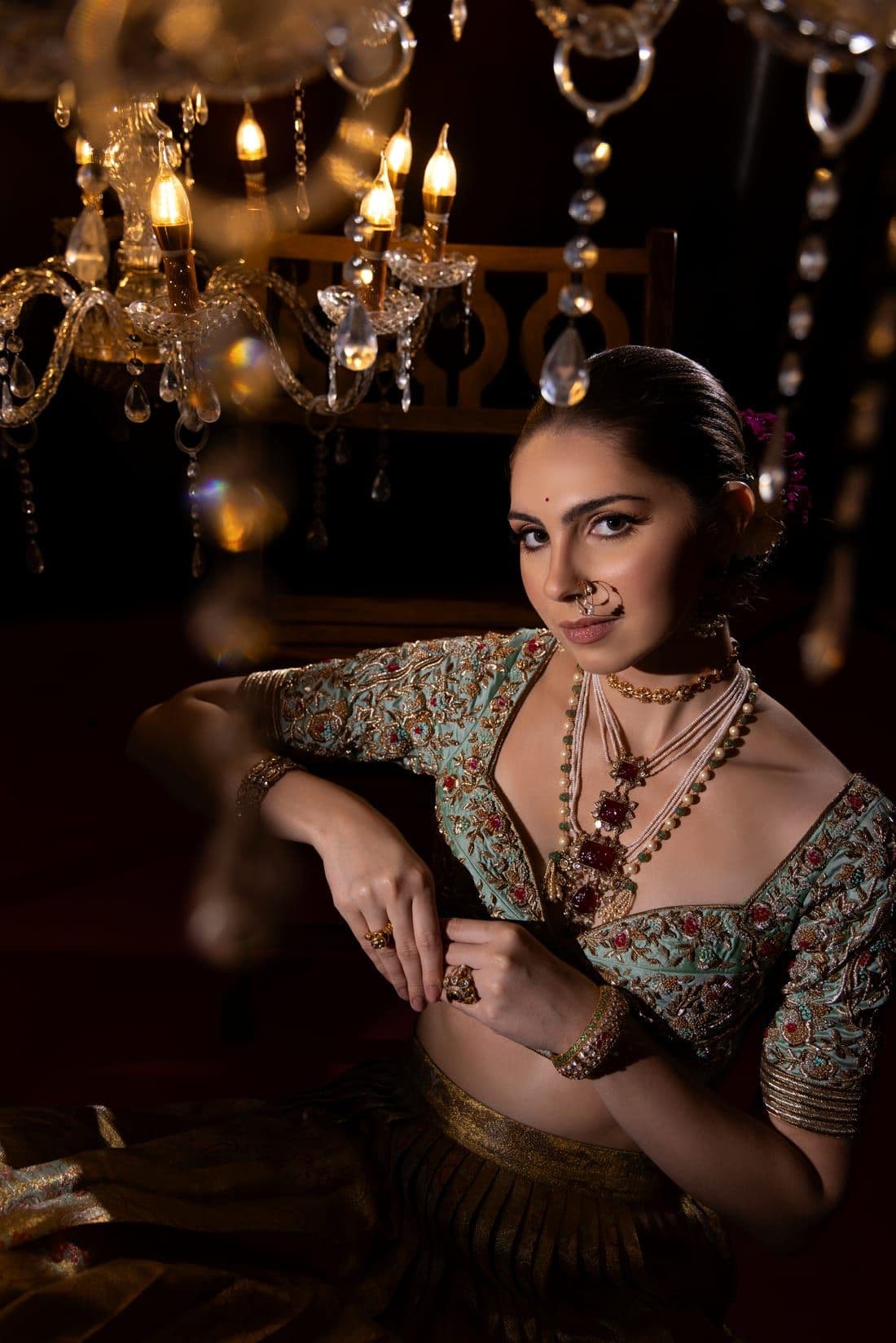 Bride in a mint embroidered blouse with a nath and layered pearl necklaces