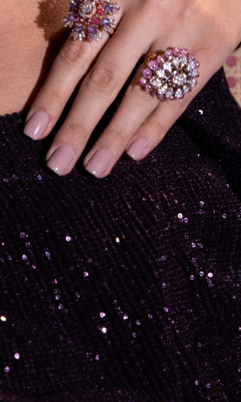 Cocktail rings on a sequinned blazer
