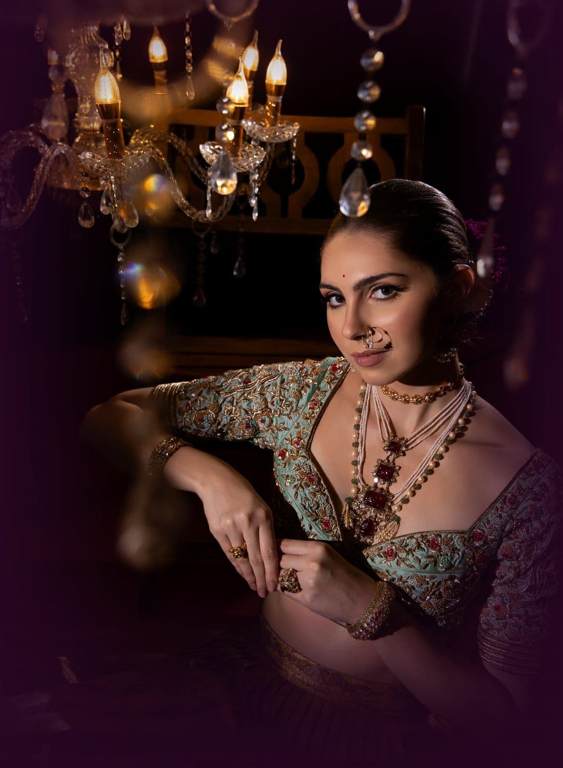 Bride in a mint embroidered blouse with a nath and layered pearl necklaces